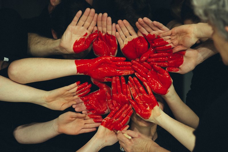 Many hands forming a heart together