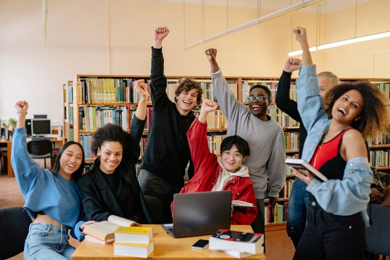 A diverse group of young people celebrating together
