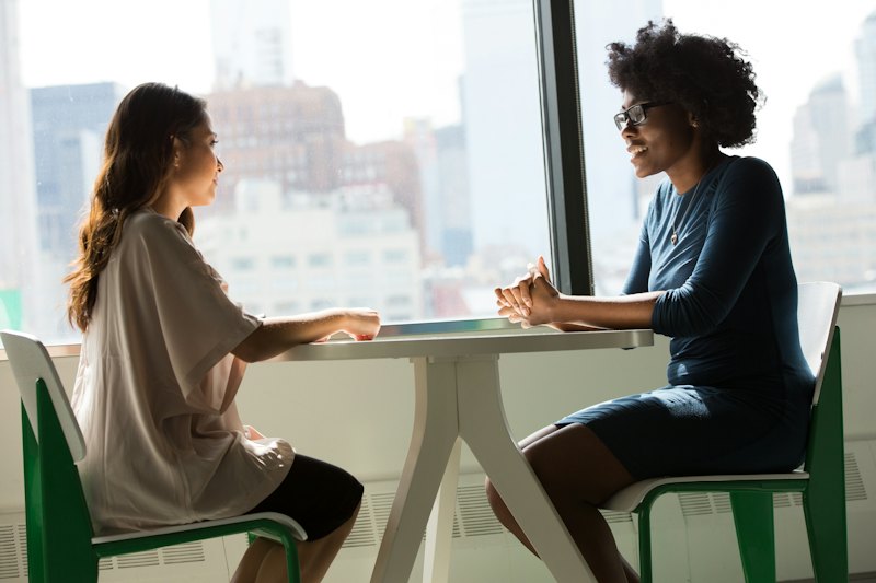 Two women having a warm one-on-one conversation at a table